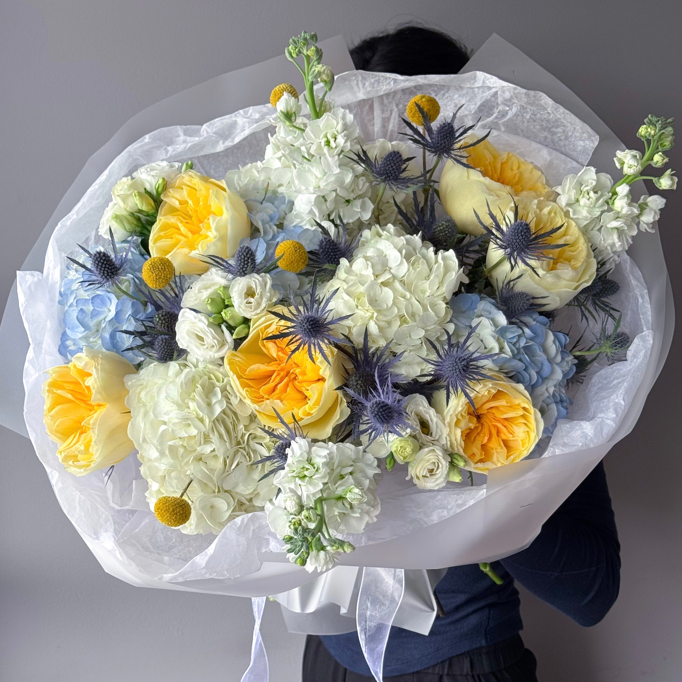 round-bouquet-lemon-sky-yellow-roses-blue-thistle-palette-bouquets-all-me-flowers-nyc