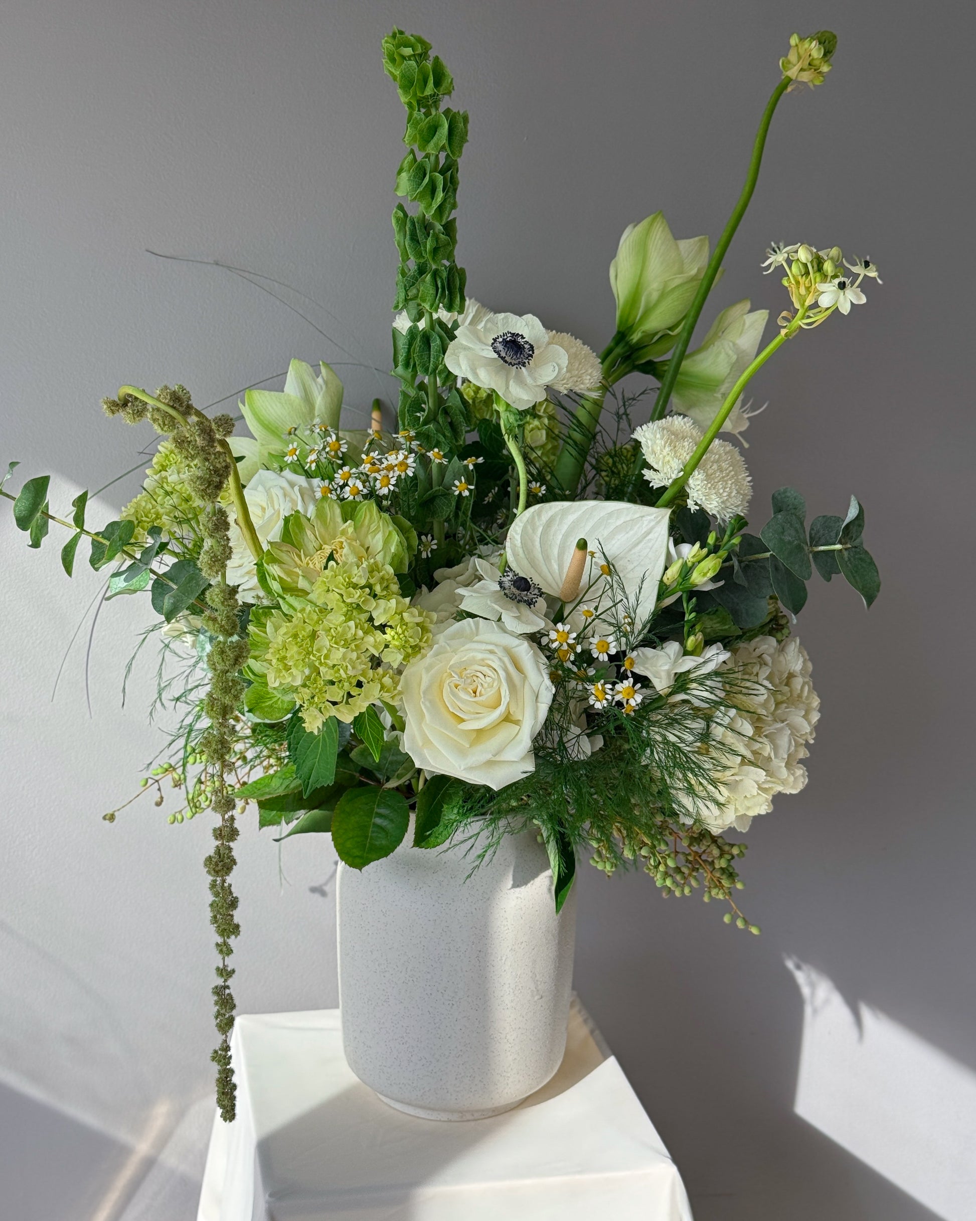 Green and white seasonal bouquet arrangement — elegant flower subscription by All Me Flowers.