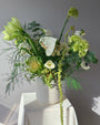 Green and white seasonal bouquet arrangement — elegant flower subscription by All Me Flowers.