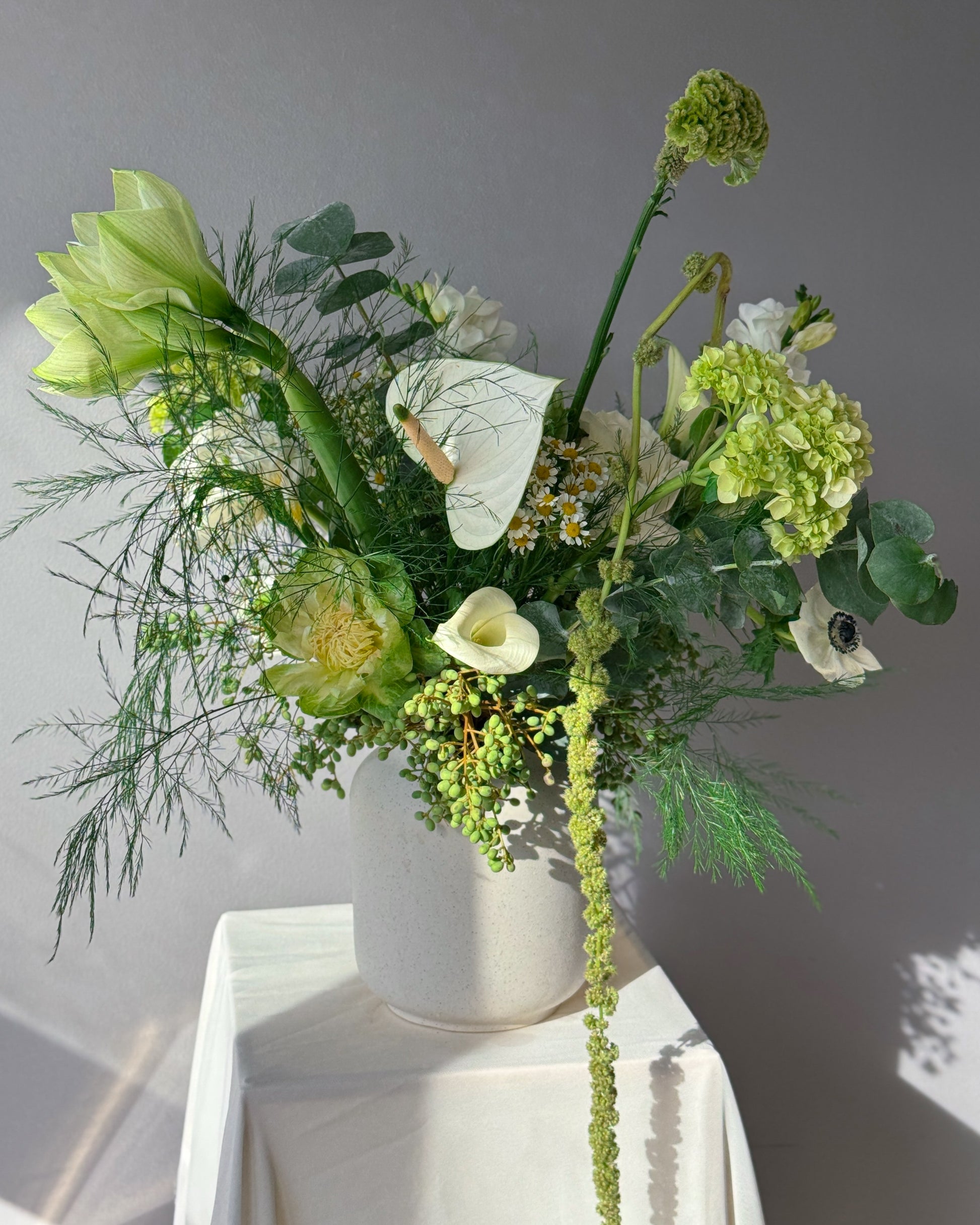 Green and white seasonal bouquet arrangement — elegant flower subscription by All Me Flowers.