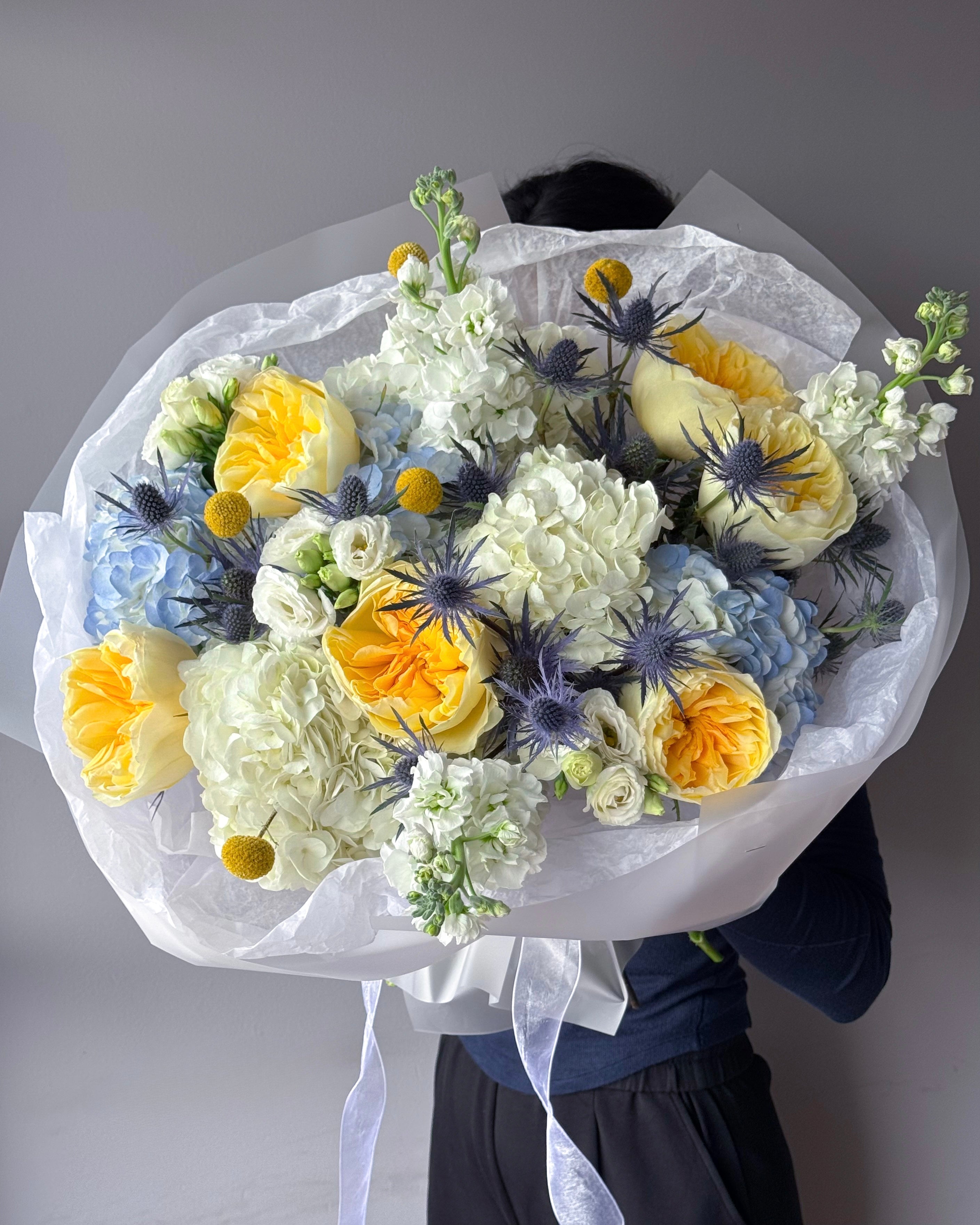 round-bouquet-lemon-sky-yellow-roses-blue-thistle-palette-bouquets-all-me-flowers-nyc