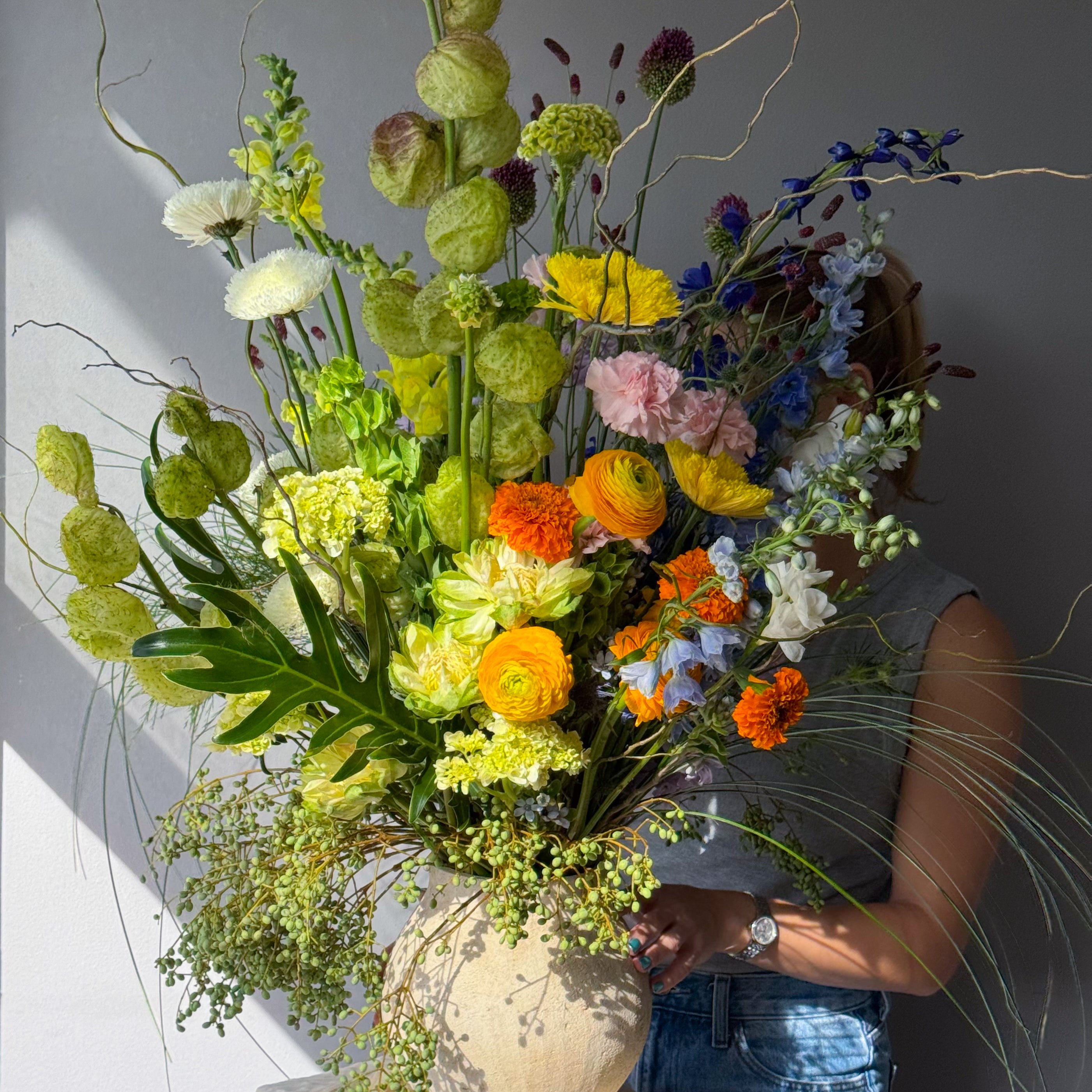 festival-colorful-flower-vase-arrangement-orange-yellow-green-blue-flowers-textural-design-palette-bouquets-NYC-florist