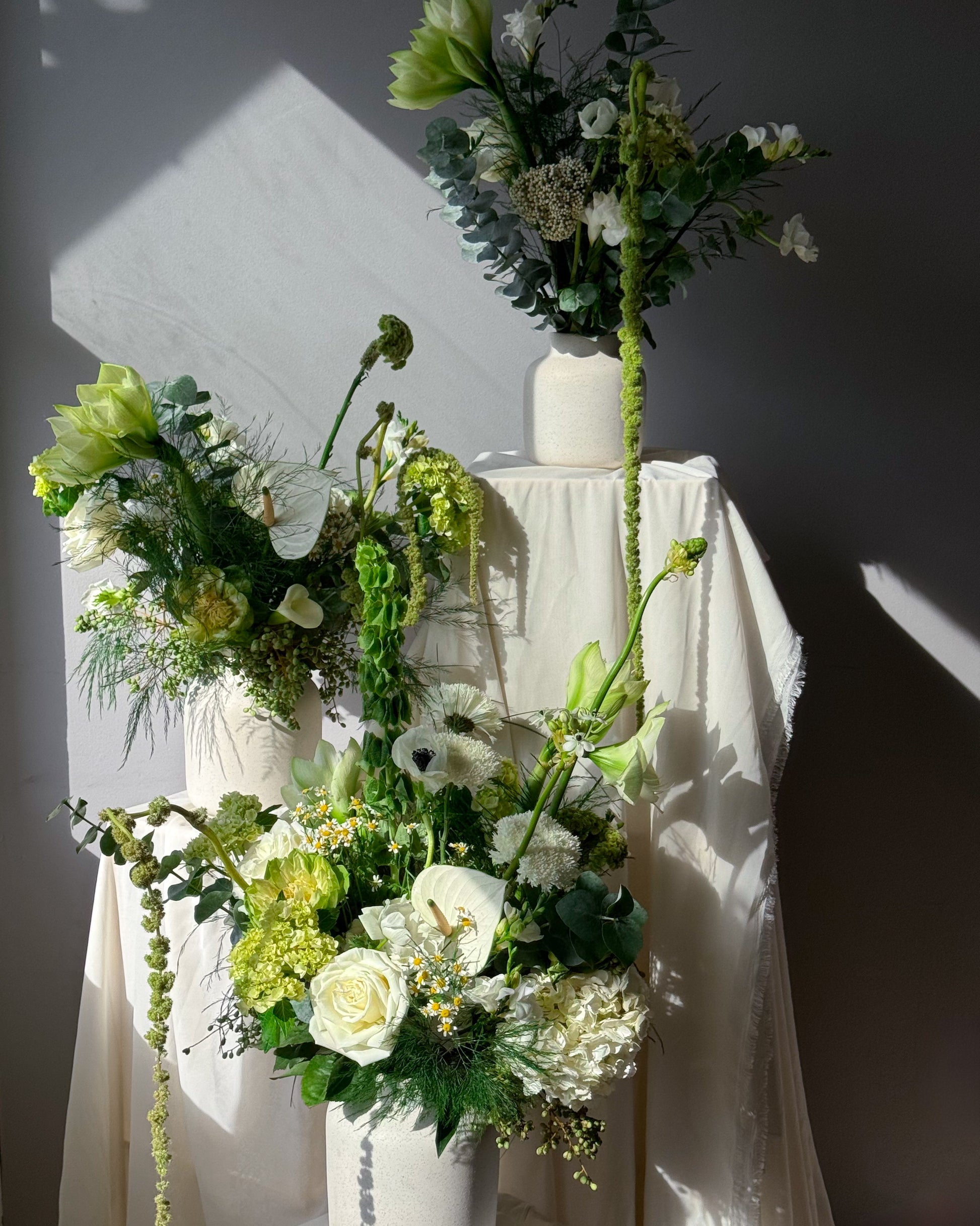 Green and white seasonal bouquet arrangement — elegant flower subscription by All Me Flowers.