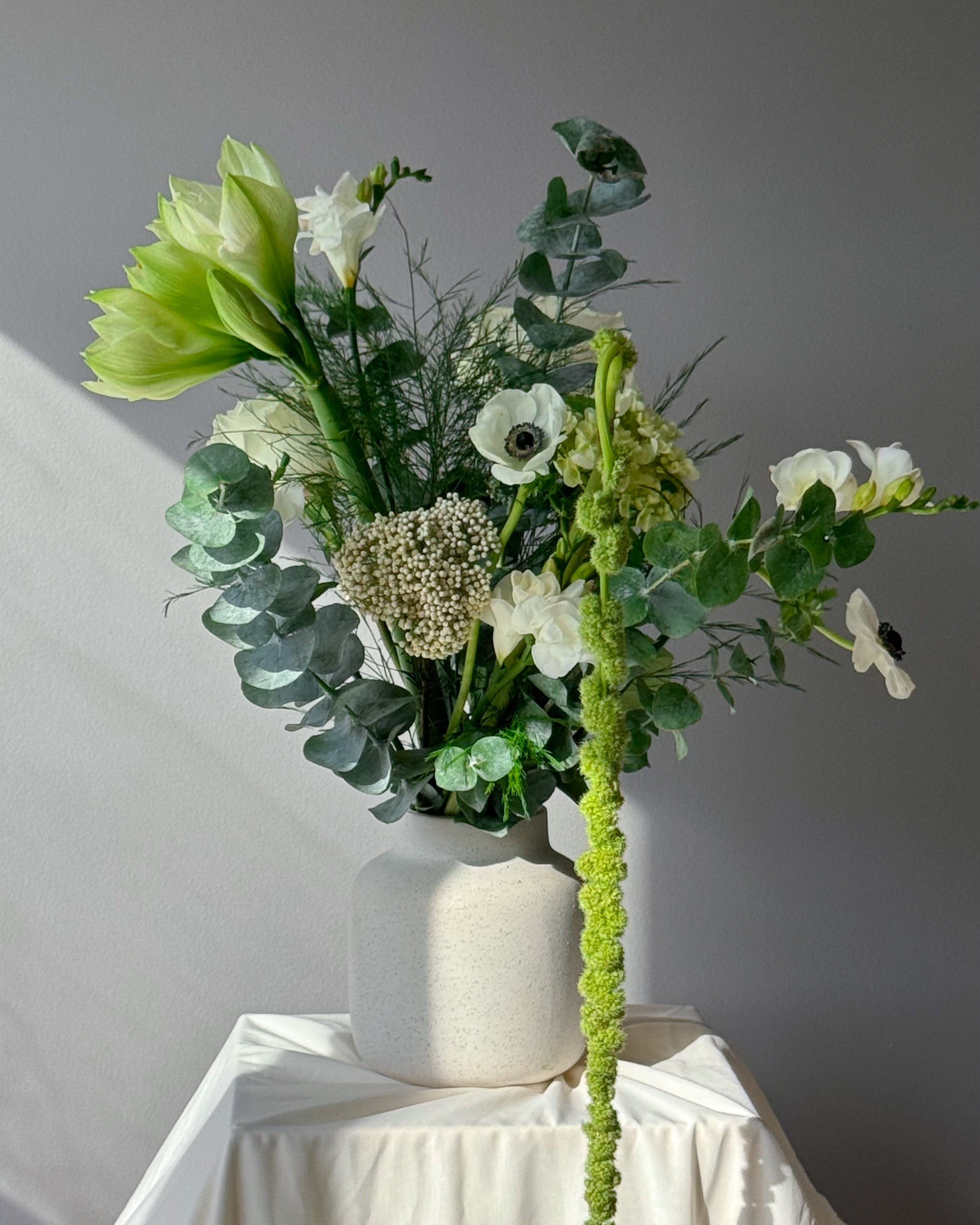 Green and white seasonal bouquet arrangement — elegant flower subscription by All Me Flowers.