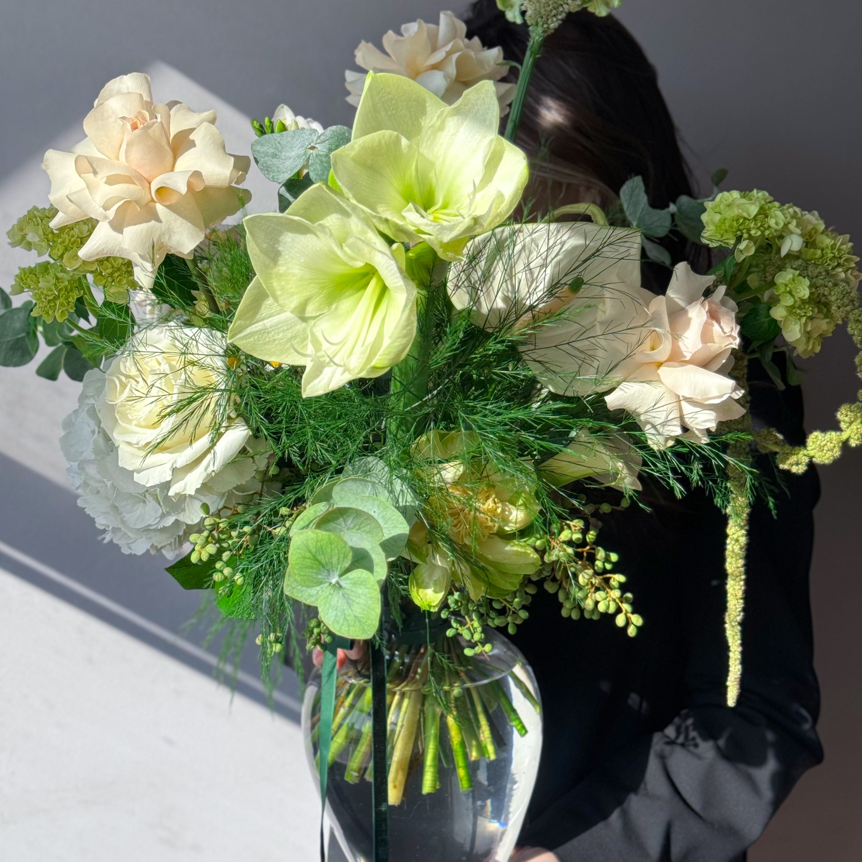 Green and white seasonal bouquet arrangement — elegant flower subscription by All Me Flowers.