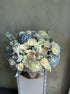 Basket “Baby Blue” - hydrangeas, roses, stock, seasonal flowers - All Me Flowers